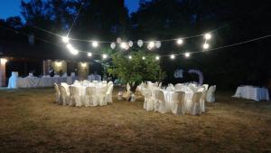 a group of tables and chairs in a field with lights at Tenuta de Maffutiis in Polla +53 photos