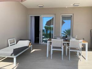 a living room with a dining room table and chairs at Apartment GARDEN in Mandre