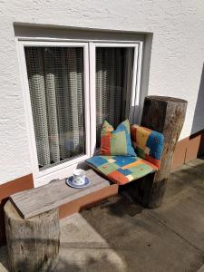 a colorful chair sitting in front of a window at Fewo Frank in Aspach