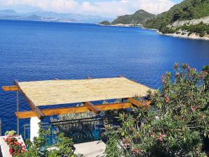 a house on the side of a body of water at Guest House Matana in Sobra