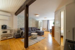 a living room with a couch and a table at Kuressaare Turu Apartment in Kuressaare