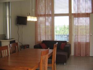 a living room with a table and a couch at Espoo Sun Cottages in Espoo