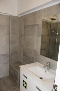 a bathroom with a sink and a shower at Beach Front Apartment 2 in Sagres
