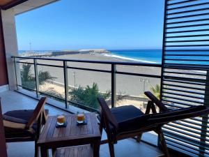 a room with a balcony with a view of the beach at Puerto playa in Tazacorte