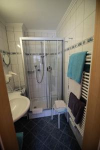 a bathroom with a shower and a sink at Hotel Garni Sonnenheim in Fiss