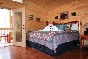 a bedroom with a bed in a log cabin at Endless Mountain Dreams in Gatlinburg