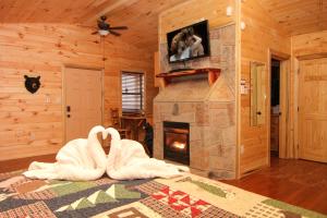 a living room with a fireplace in a log cabin at Endless Mountain Dreams in Gatlinburg +4 photos