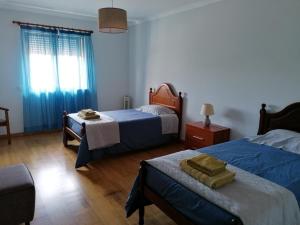 Ένα ή περισσότερα κρεβάτια σε δωμάτιο στο Arquinha Apartment