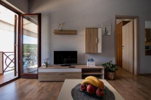 a living room with a table with a bowl of fruit at Apartment Blašković in Novigrad Dalmatia