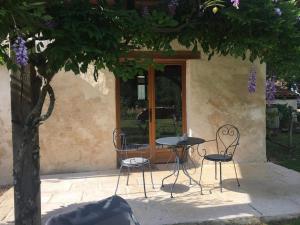 a table and chairs in front of a building at Les Landes De Mauchat in Saint-Martin-de-Fressengeas