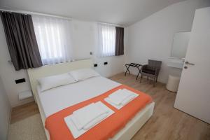a bedroom with a bed and a chair in it at Mayana in Cesarica