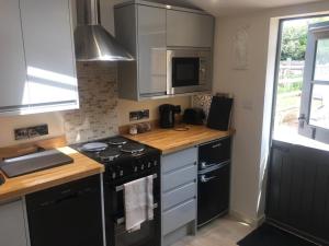 a kitchen with a stove and a counter top at Russet in Yate