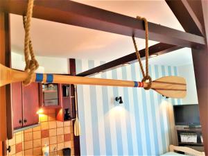 a wooden paddle hanging from a ceiling in a kitchen at Mieszkanko na lato z balkonem. in Puck