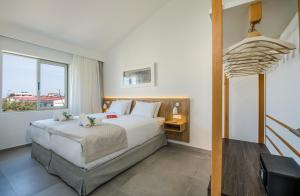 a bedroom with a large bed and a window at Lotus Hotel Apartments in Kato Daratso +57 photos