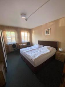 a bedroom with a large bed and two chairs at Hotel-Gasthof "Alter Ritter" in Rothenburg ob der Tauber