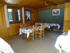 a dining room with tables and chairs in a cabin at Chalet La Barme Les Houches Vallée de Chamonix in Les Houches