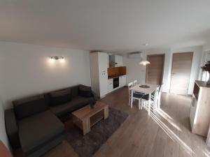 a living room with a couch and a table at Apartment Bruno in Mali Lošinj