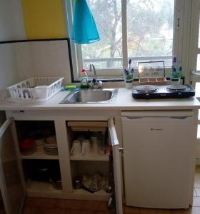 a kitchen counter with a sink and a window at Katia's Apartments in Sarti +26 photos