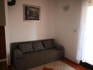 a couch in a living room with a picture on the wall at Apartment Plavia Biograd in Biograd na Moru