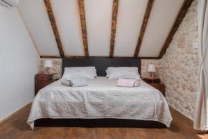 a bedroom with a bed with two pillows on it at Ivićev san in Tučepi