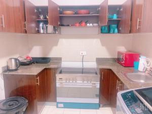a small kitchen with a stove and a sink at Villa Townhouse Al waha king Abdallah economy city in King Abdullah Economic City