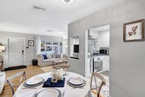 a kitchen and living room with a table and chairs at Cozy and Charming in SoSo in West Palm Beach +19 photos