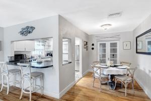 a kitchen and dining room with a table and chairs at Cozy and Charming in SoSo in West Palm Beach