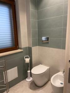 a bathroom with a toilet and a sink at Villa Torre degli Ulivi in Corigliano Calabro +12 photos