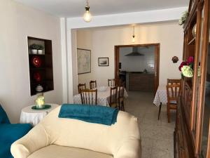 a living room with a couch and a table and chairs at CASA CENTRICA EN O GROVE in O Grove