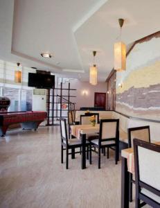 a restaurant with tables and chairs and a pool table at Yves 2 Bed apart at Sun Village Sunny Beach not far away from the sea in Sunny Beach