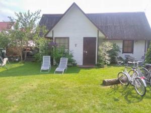 a house with chairs and a yard with a house at Vahtra Vacation House in Käsmu