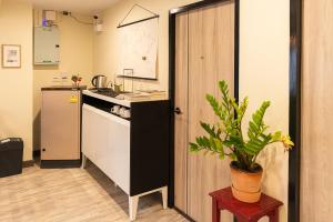 a kitchen with a counter and a potted plant at I Rich Residence in Bangkok