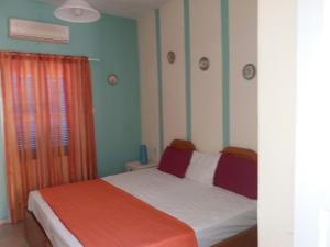A bed or beds in a room at Panormos,Irene's Studio