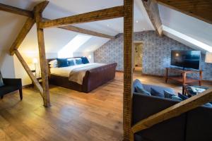 a bedroom with a bed and a living room at Hotel du Vin & Bistro Harrogate in Harrogate