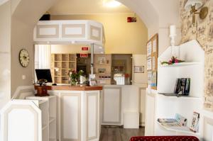 a kitchen with white cabinets and a counter top at Gyula Panzio in Gyula