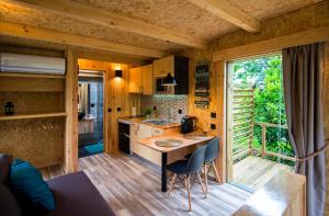 a kitchen with a table and chairs in a cabin at Welcome to Gerês-Green view in Vieira do Minho