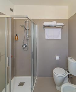 a bathroom with a shower and a toilet at Hotel Spinelli in Viareggio