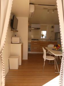 a kitchen and dining room with a table and chairs at Blue Wave Mobile Home in Biograd na Moru