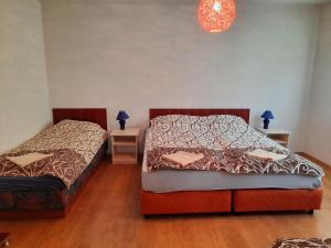 a bedroom with two beds and two tables with lamps at Bajam Apartments in Ohrid