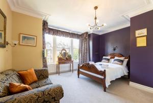 a bedroom with a bed and a couch at Wynnstay House in Harrogate