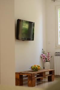 a tv hanging on a wall above a coffee table at Studio apartman MARINA in Vodice