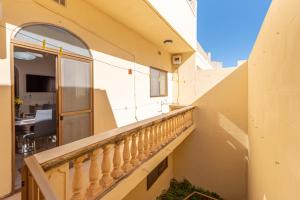 a balcony of a building with a railing and a window at Cloud 9 Residence in Għajnsielem