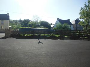 a parking lot with a gazebo in a yard at Inspiration Lodge in Anascaul