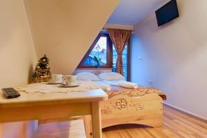 a bedroom with a bed with a christmas tree at Willa Chaber in Zakopane