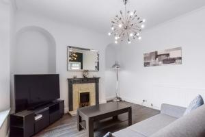 a living room with a tv and a fireplace at Clarence Heights in Newport