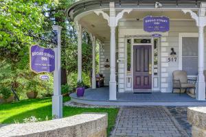 a front porch of a house with a purple door at Broad Street Inn in Nevada City