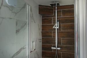 a shower with a glass door in a bathroom at Cosy Central Canterbury - Modern Victorian in Kent