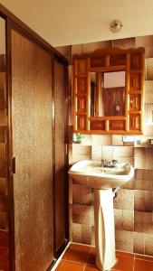 a bathroom with a sink and a mirror at Meson Yohualichan in Cuetzalán del Progreso