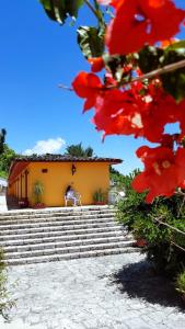 a person sitting on a chair in front of a building at Meson Yohualichan in Cuetzalán del Progreso