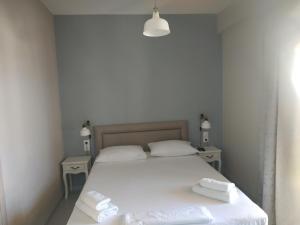 シヴォタにあるAnGeo Apartmentsのベッドルーム1室(白いベッド1台、タオル付)